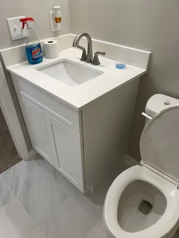 a bathroom with a toilet sink and shower