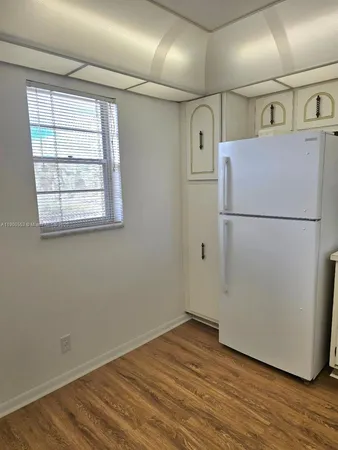 a white refrigerator freezer sitting in a kitchen