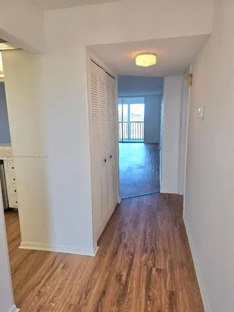 a view of hallway with wooden floor and window