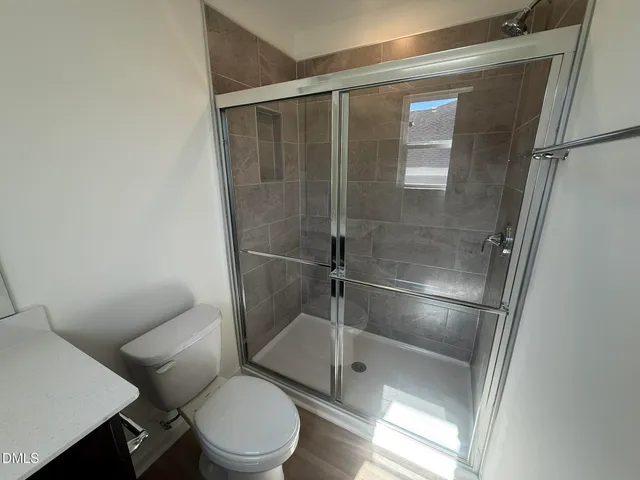a bathroom with a toilet and a shower