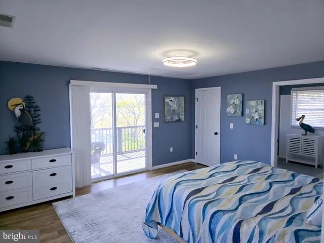 a bathroom with a sink a toilet and a window