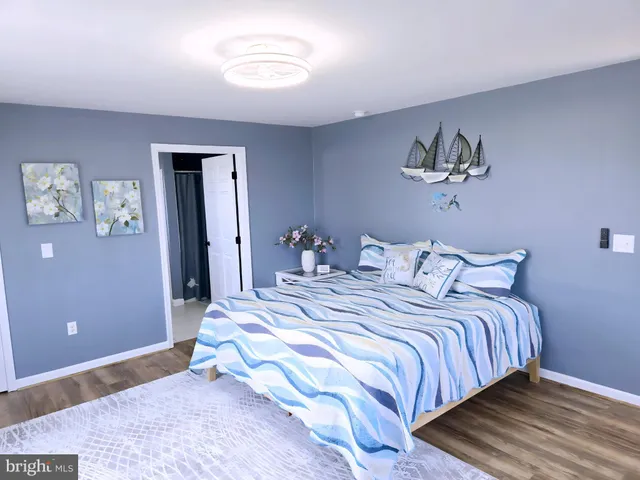 a view of a patio with table and chairs potted plants and a large tree
