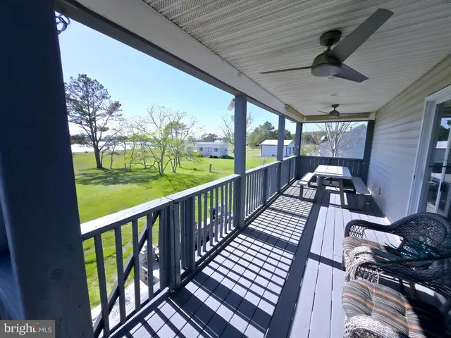 a view of a patio with dining table and chairs