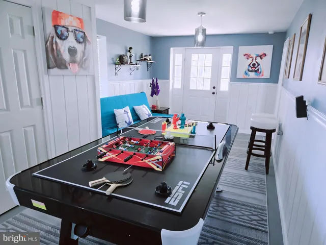 a view of a swimming pool and lounge chairs in back yard of the house