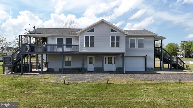 a living room with furniture a flat screen tv and a window