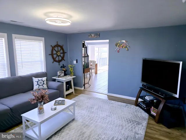 a kitchen with stainless steel appliances kitchen island granite countertop a white cabinets a stove top oven a sink and dishwasher