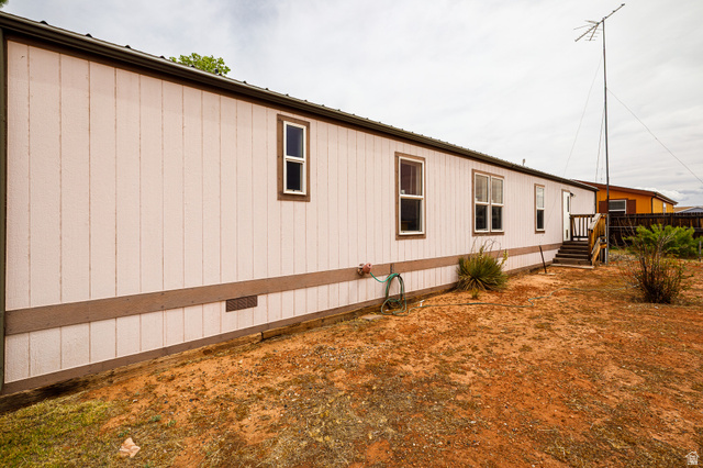 740 Riddle Drive Fredonia, AZ 86022 - Photo 17 of 20 White vertical panel siding with brown trim and multiple windows