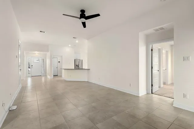 a view of a livingroom with a kitchen space and a window