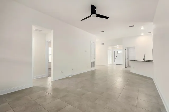 a view of a kitchen with a refrigerator and window