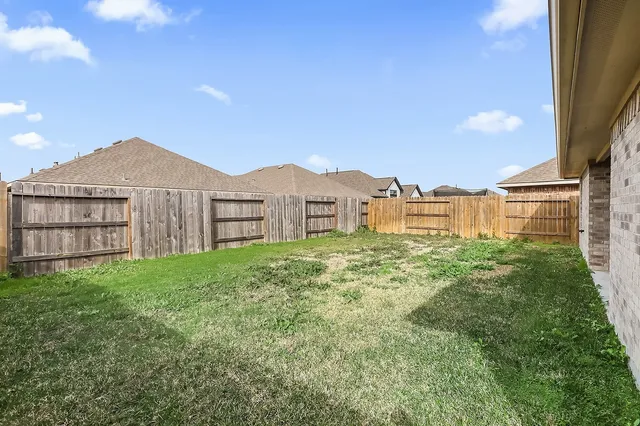 a view of a house with a yard and table and chairs