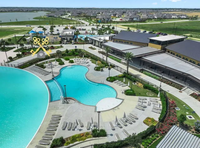 an aerial view of a swimming pool with a yard