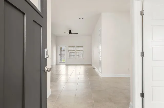 a view of a hallway with wooden cabinet