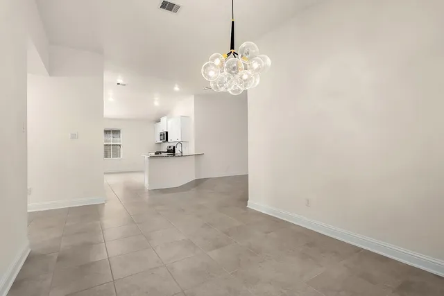 a view of a kitchen with a sink and refrigerator