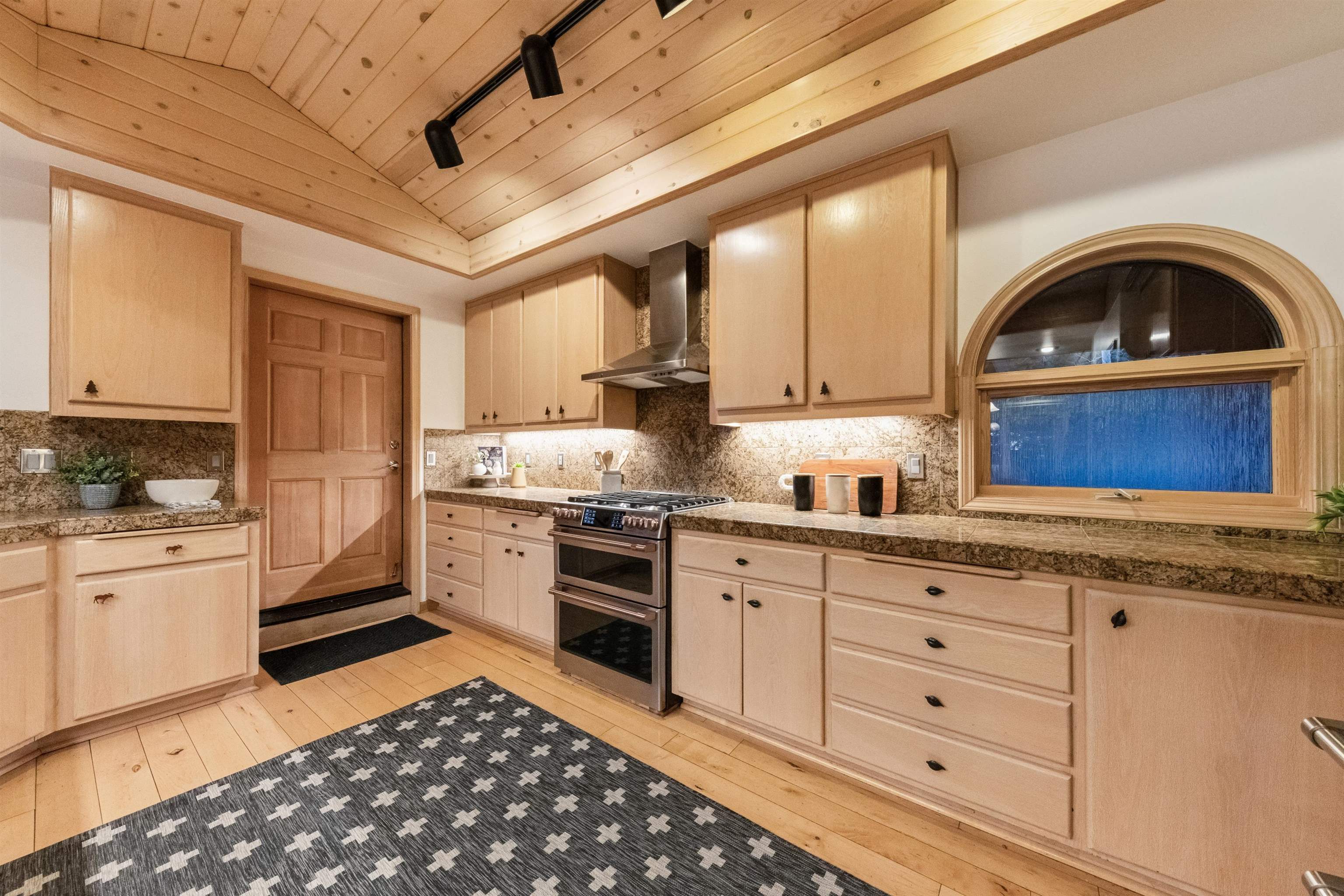 12705 Falcon Point Place Truckee, CA 96161 - Photo 11 of 28 a kitchen with granite countertop a sink stainless steel appliances and cabinets