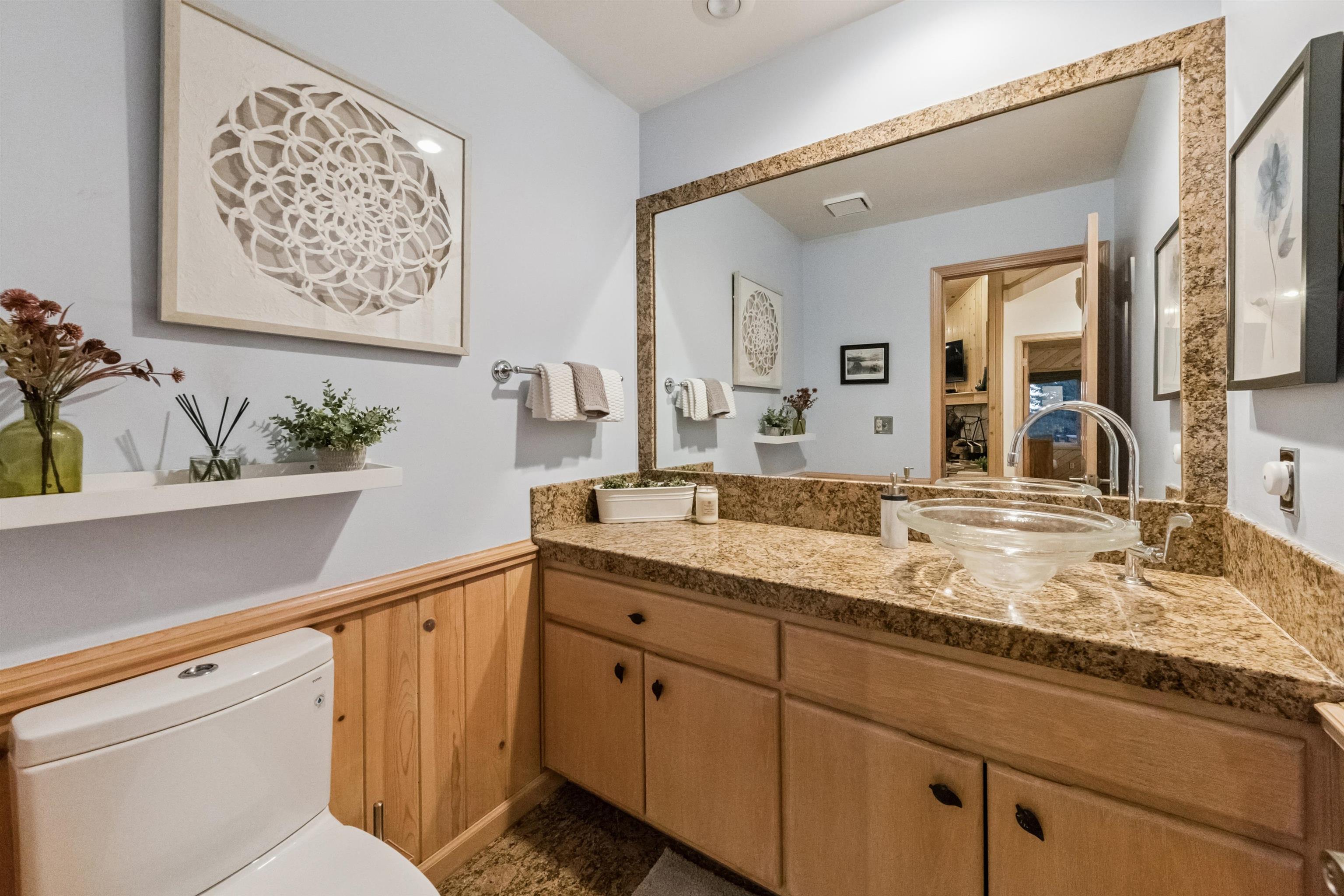 12705 Falcon Point Place Truckee, CA 96161 - Photo 12 of 28 a bathroom with a granite countertop sink mirror and vanity