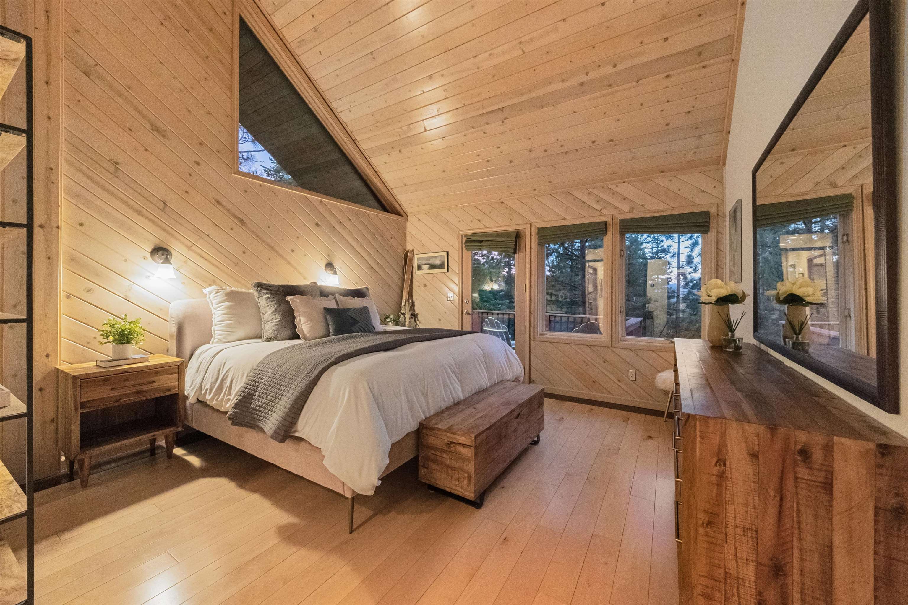 12705 Falcon Point Place Truckee, CA 96161 - Photo 13 of 28 a spacious bedroom with a bed couch and a large window with wooden floor