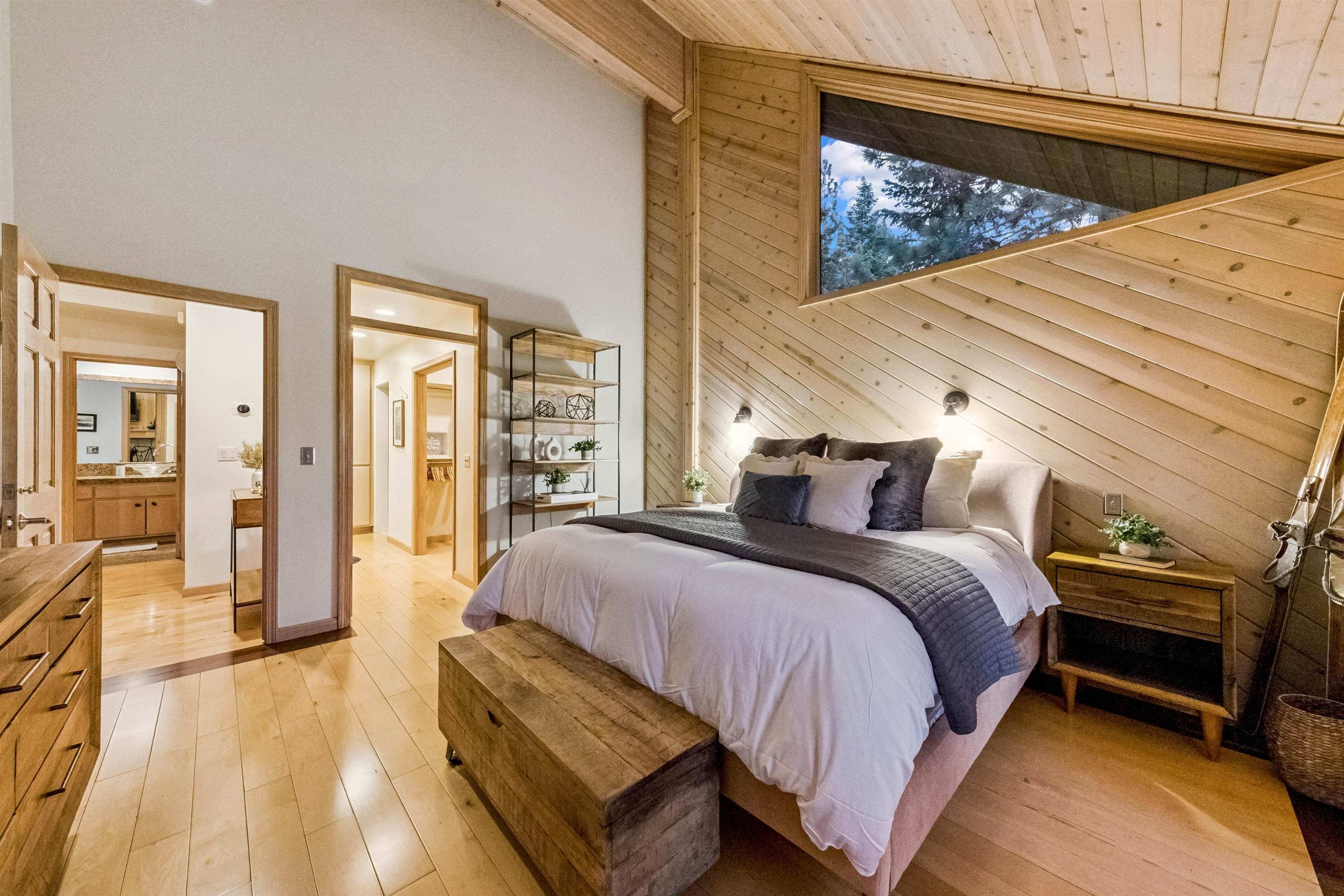 12705 Falcon Point Place Truckee, CA 96161 - Photo 14 of 28 a spacious bedroom with a bed a couch and large window with outer view