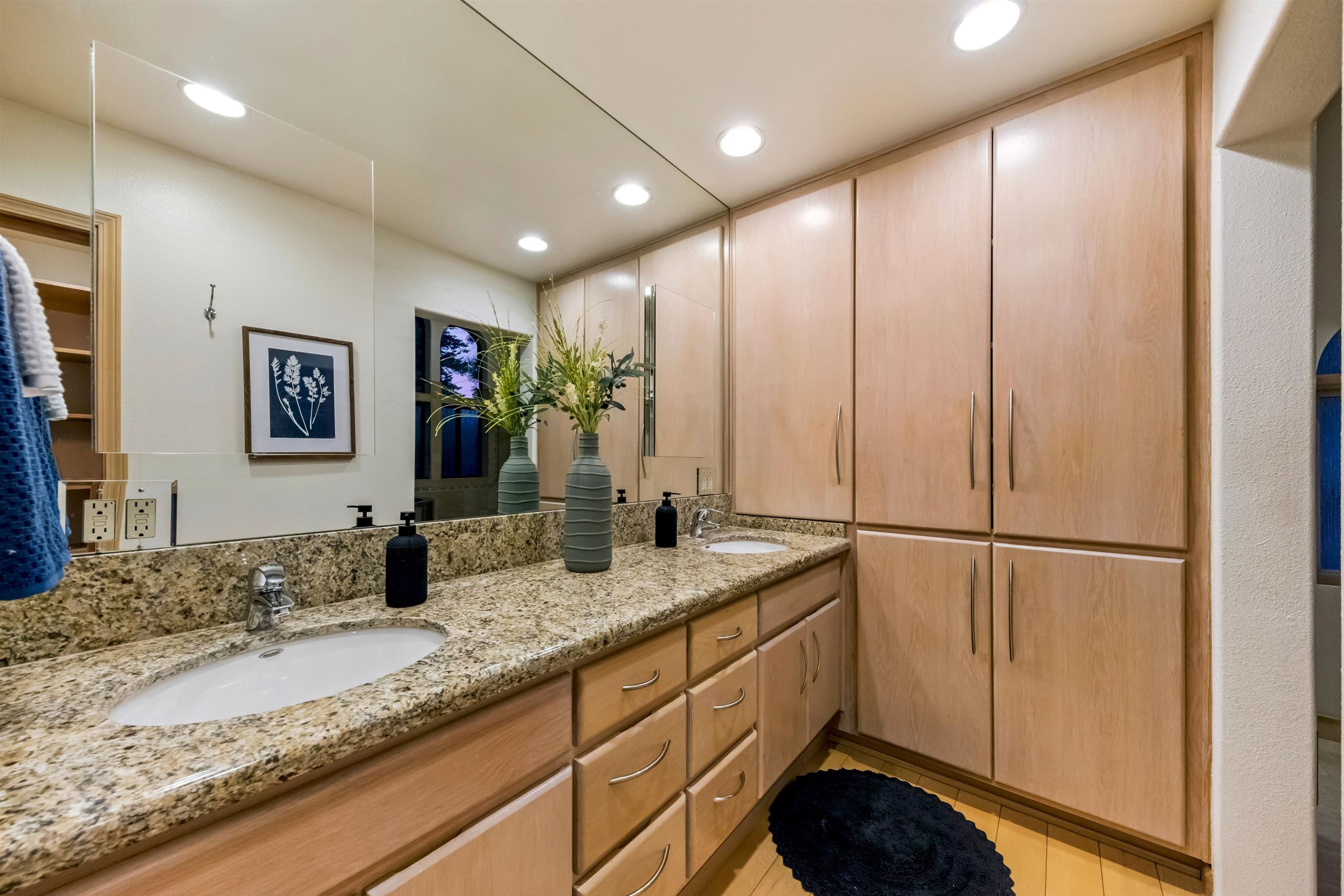 12705 Falcon Point Place Truckee, CA 96161 - Photo 15 of 28 a bathroom with a granite countertop sink and a mirror