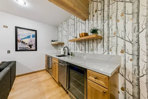 a kitchen with stainless steel appliances granite countertop a sink and a white cabinets