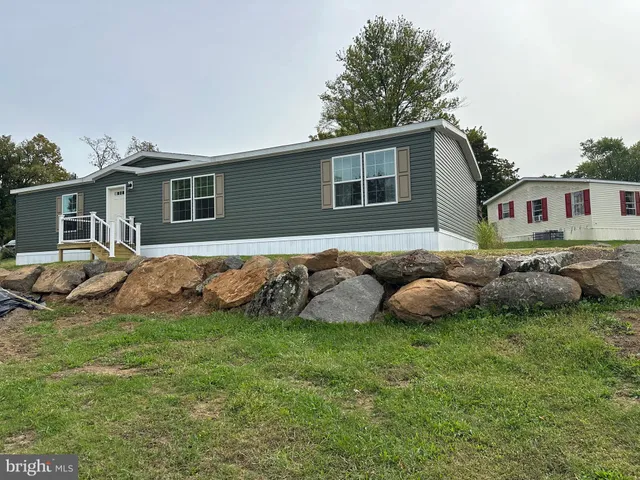 a view of a house with a backyard porch and sitting area