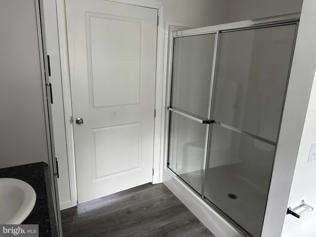 a bathroom with a glass shower door