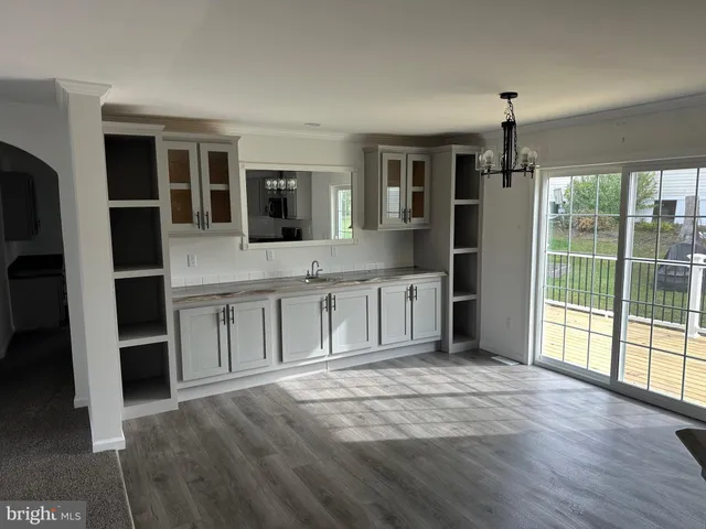 a spacious bathroom with a granite countertop sink and a mirror