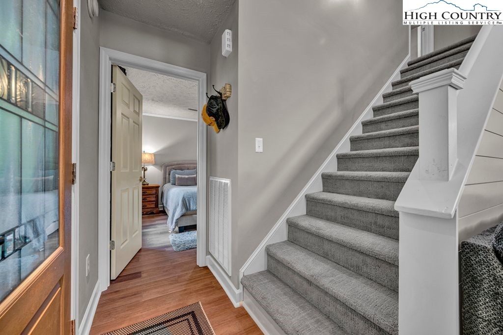 607 Charter Hills Road Beech Mountain, NC 28604 - Photo 6 of 31 a view of a hallway with wooden floor and staircase