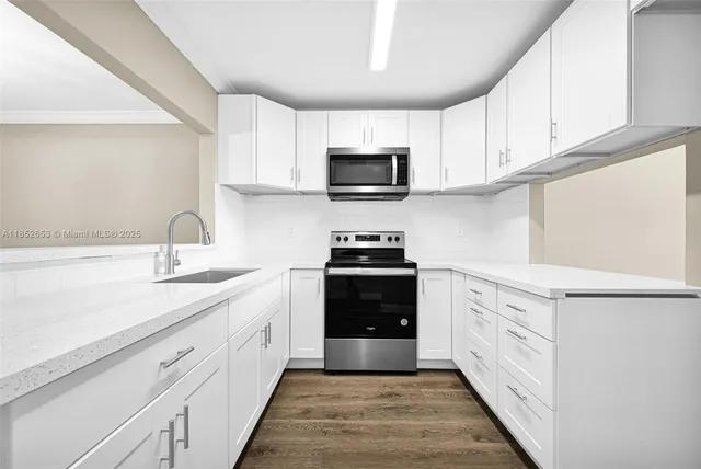 a kitchen with a sink stove and microwave