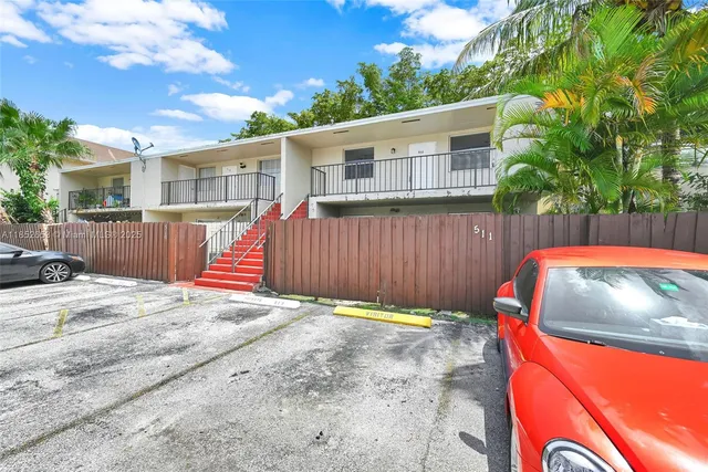 a backyard of a house with table and chairs
