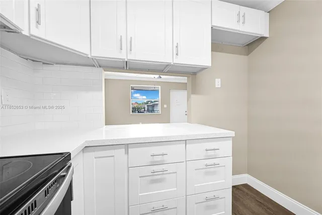 a view of a room with wooden floor and chandelier