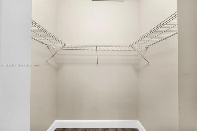 a white toilet sitting next to a bathroom sink and a mirror