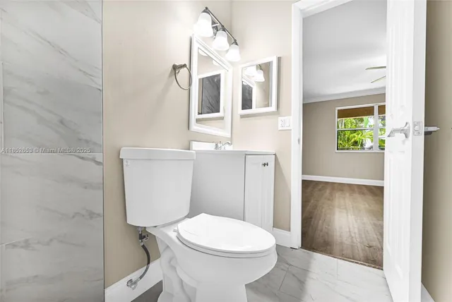 an empty room with wooden floor & windows