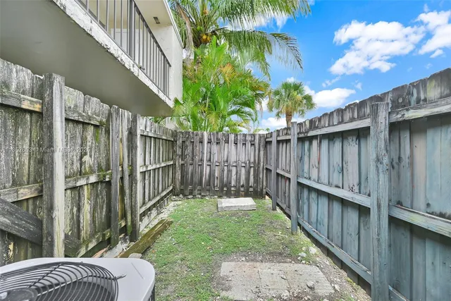 a view of a chair and table in the backyard
