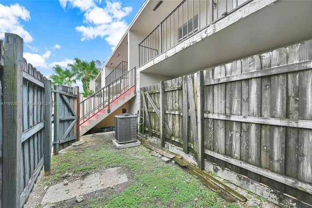 an aerial view of multiple houses with yard