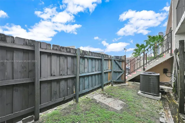 a view of a patio with a table and chairs