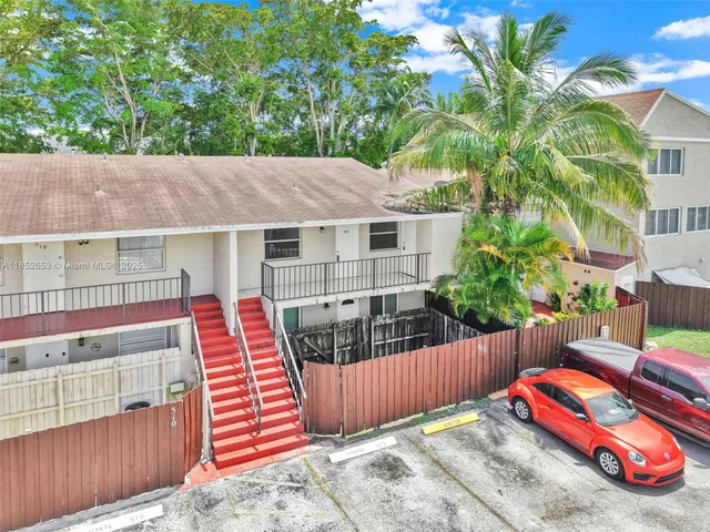 an aerial view of residential houses with outdoor space