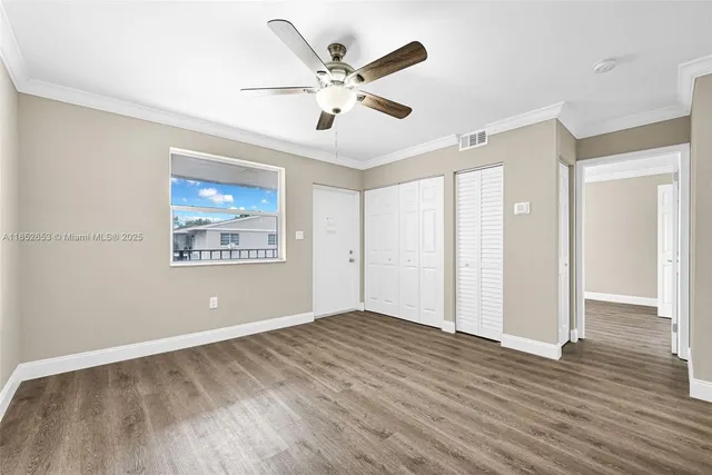 a view of a hallway with wooden floor