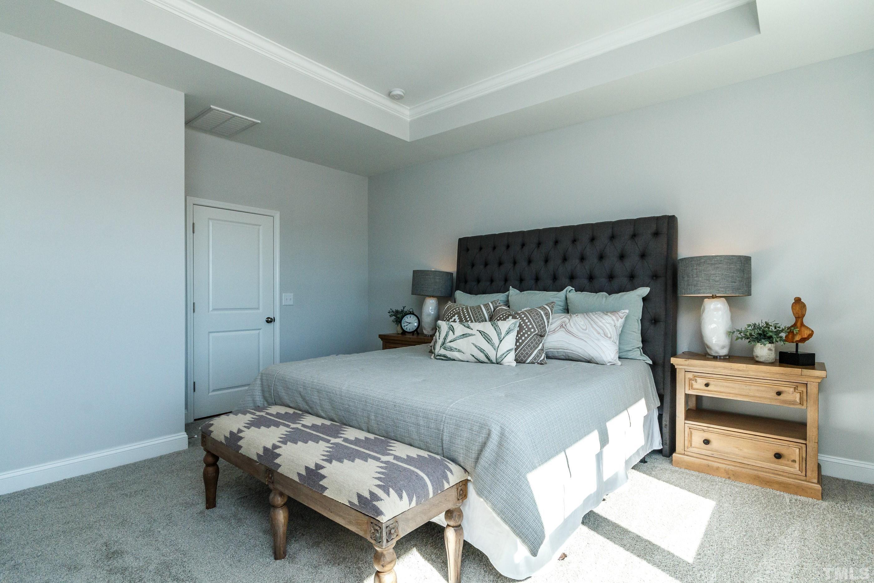 3109 Dunnock Drive, Unit 5 Durham, NC 27713 - Photo 13 of 25 a bedroom with a bed and a lamp on dresser