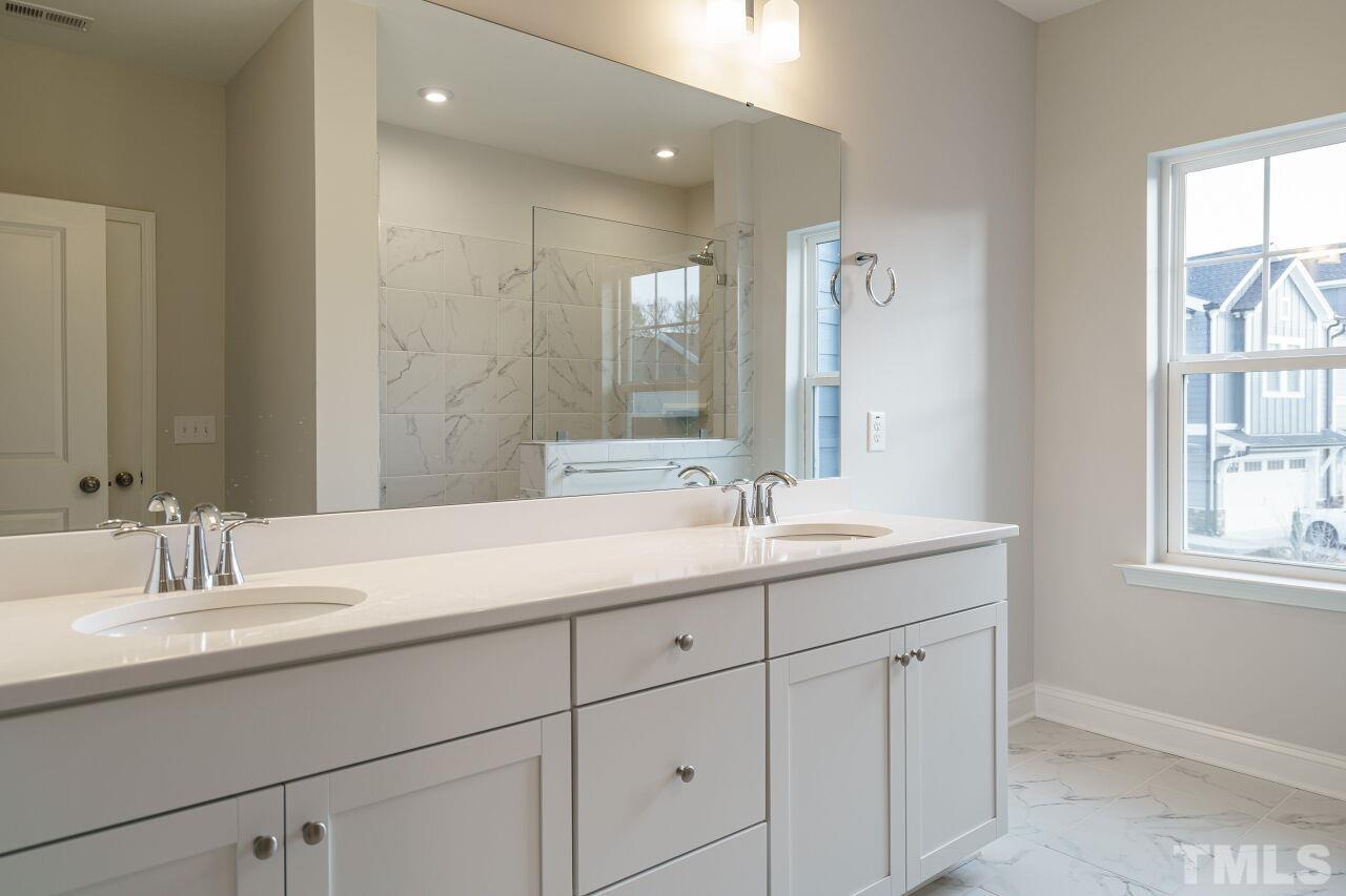 3109 Dunnock Drive, Unit 5 Durham, NC 27713 - Photo 14 of 25 a bathroom with a sink and a mirror