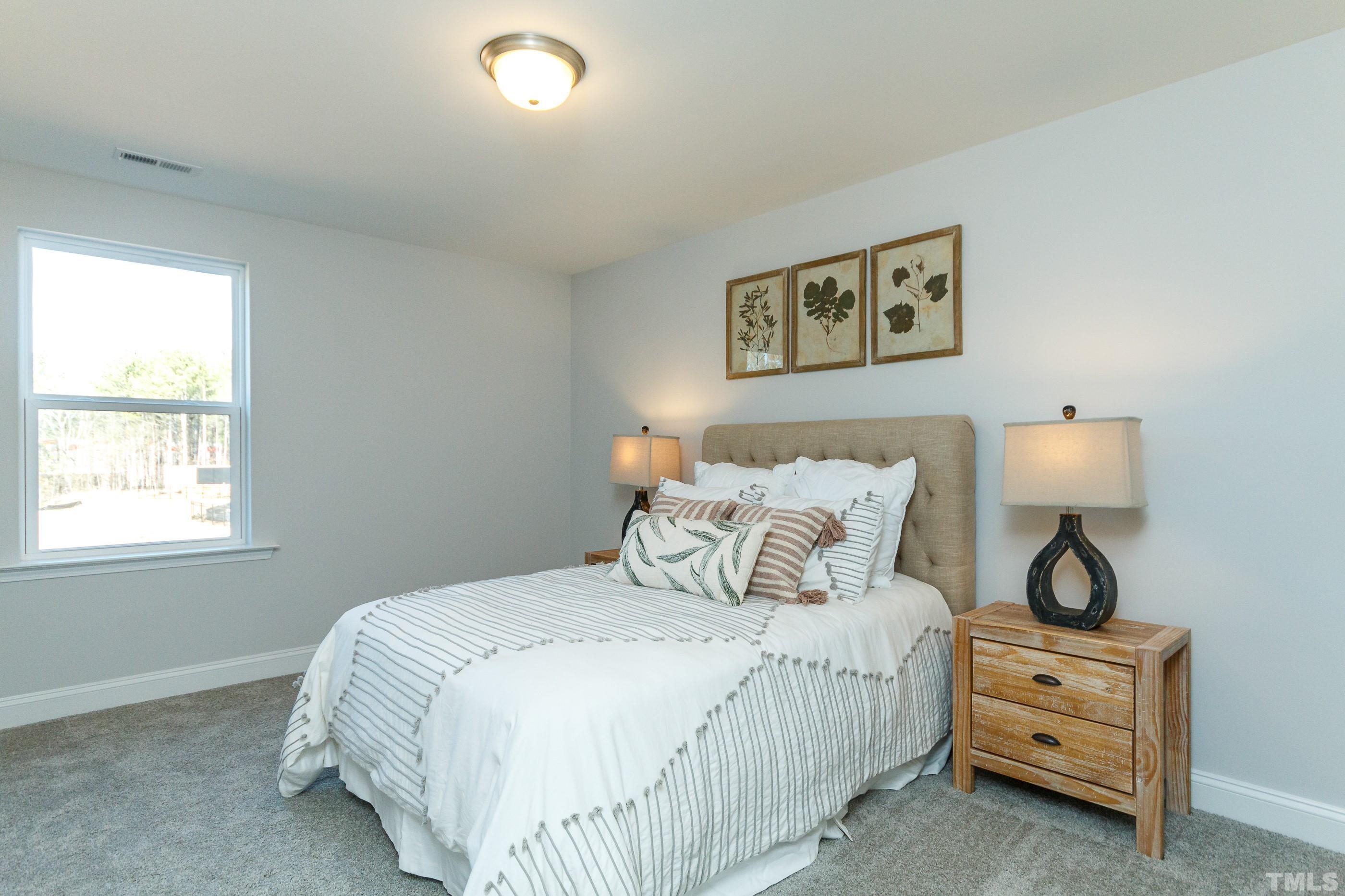 3109 Dunnock Drive, Unit 5 Durham, NC 27713 - Photo 18 of 25 a bedroom with bed and a night stand