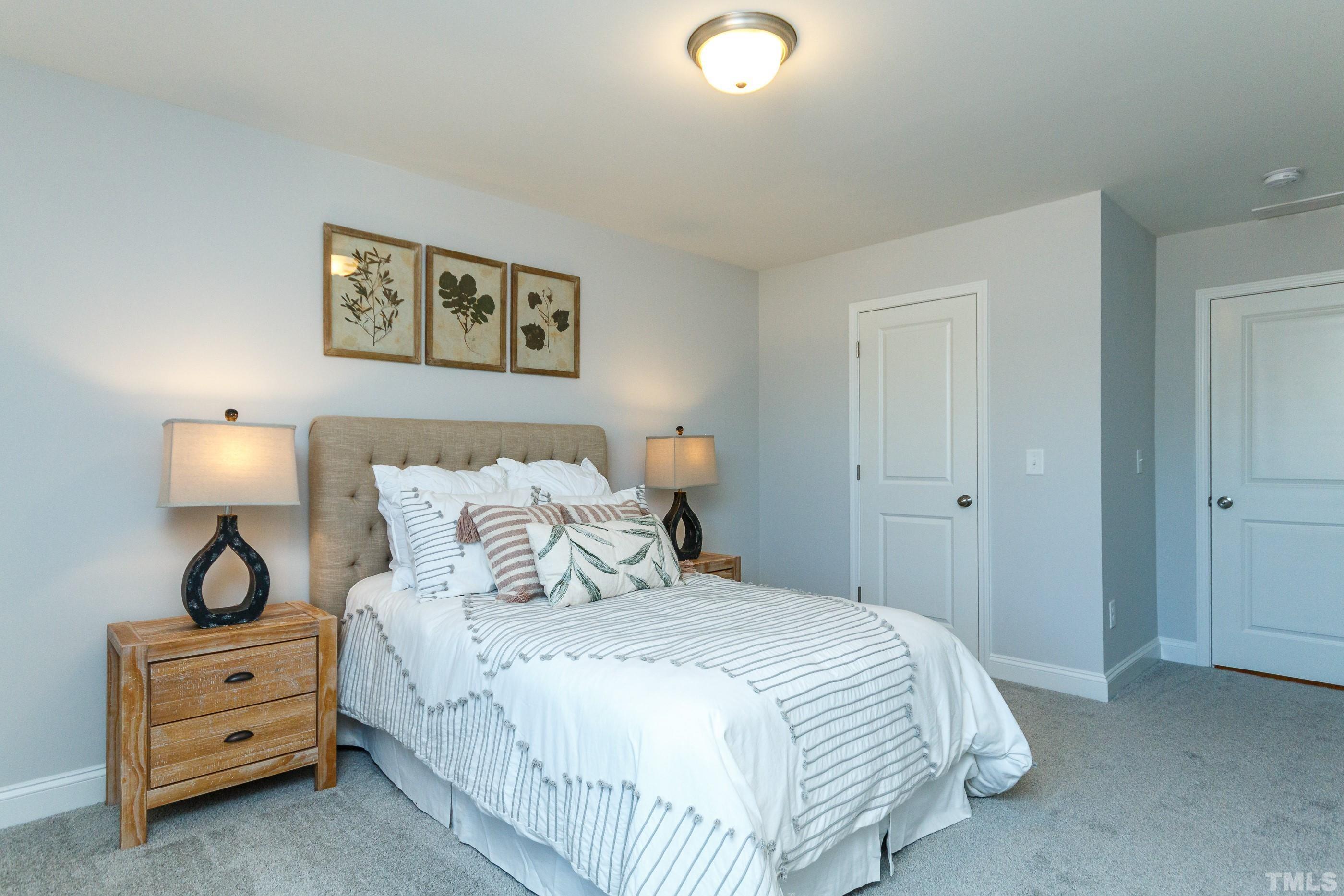 3109 Dunnock Drive, Unit 5 Durham, NC 27713 - Photo 19 of 25 a bedroom with a bed and a lamp on dresser
