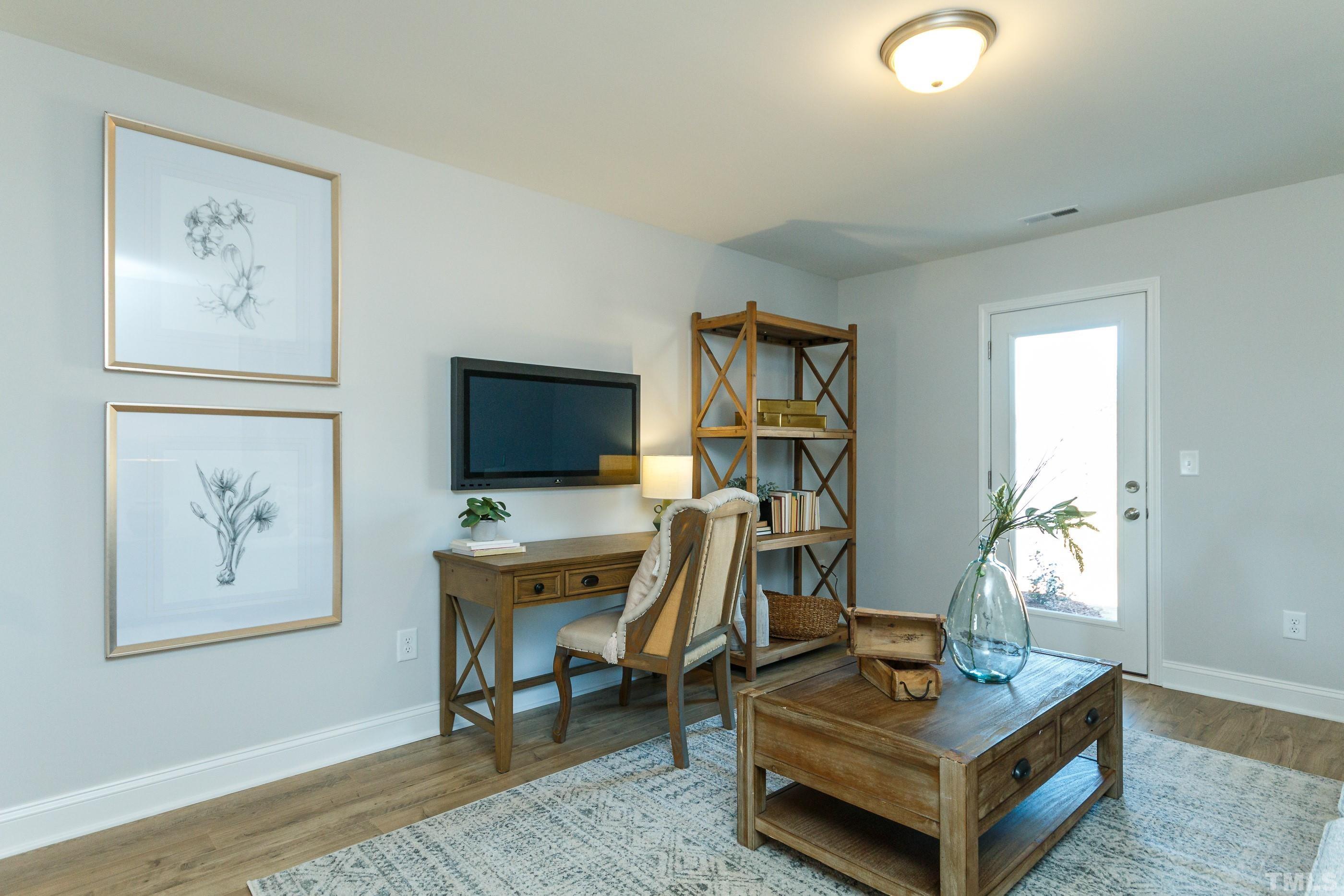 3109 Dunnock Drive, Unit 5 Durham, NC 27713 - Photo 23 of 25 a living room with furniture a flat screen tv and a window