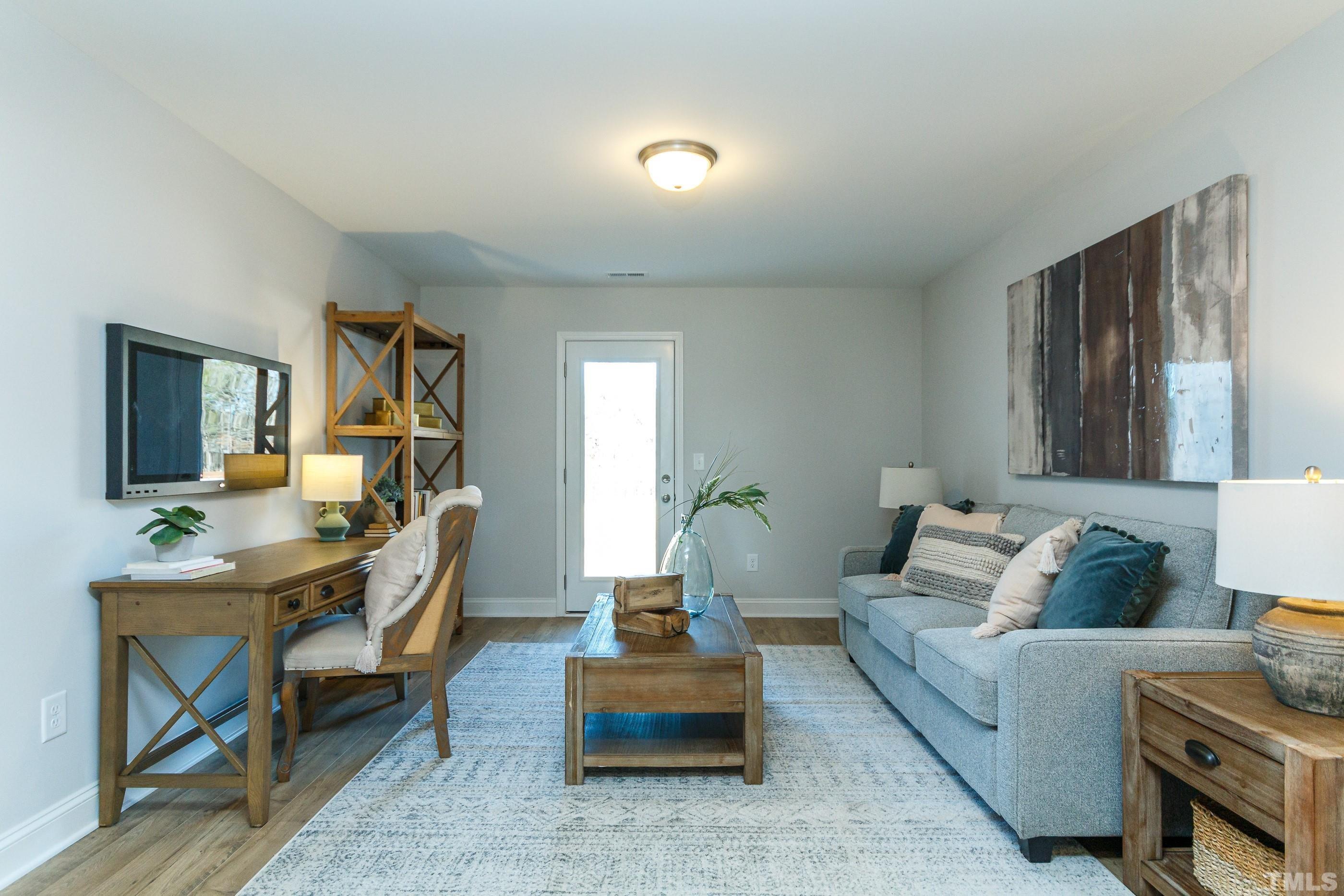 3109 Dunnock Drive, Unit 5 Durham, NC 27713 - Photo 24 of 25 a living room with furniture and a table