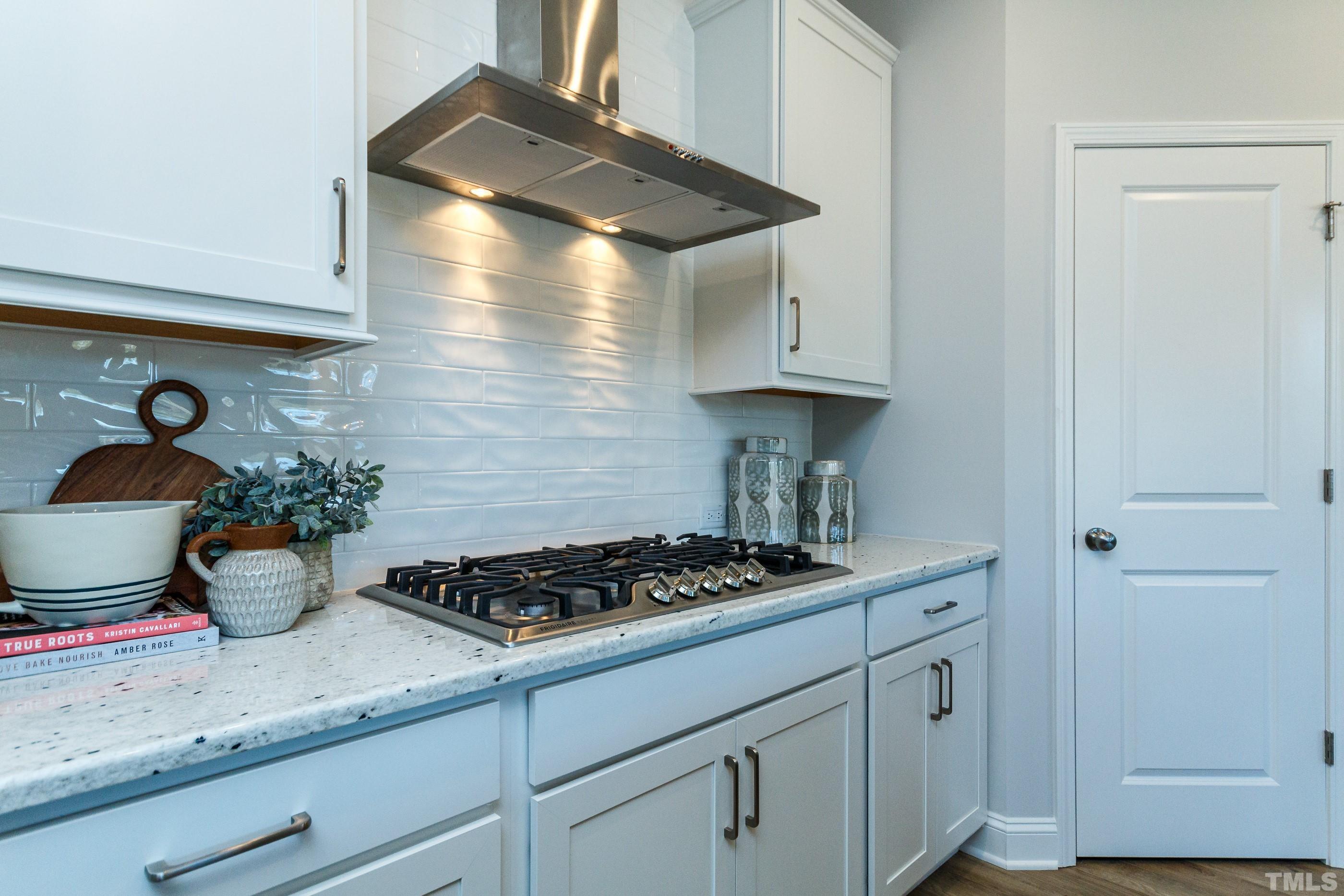 3109 Dunnock Drive, Unit 5 Durham, NC 27713 - Photo 5 of 25 a kitchen with stainless steel appliances a stove and cabinets