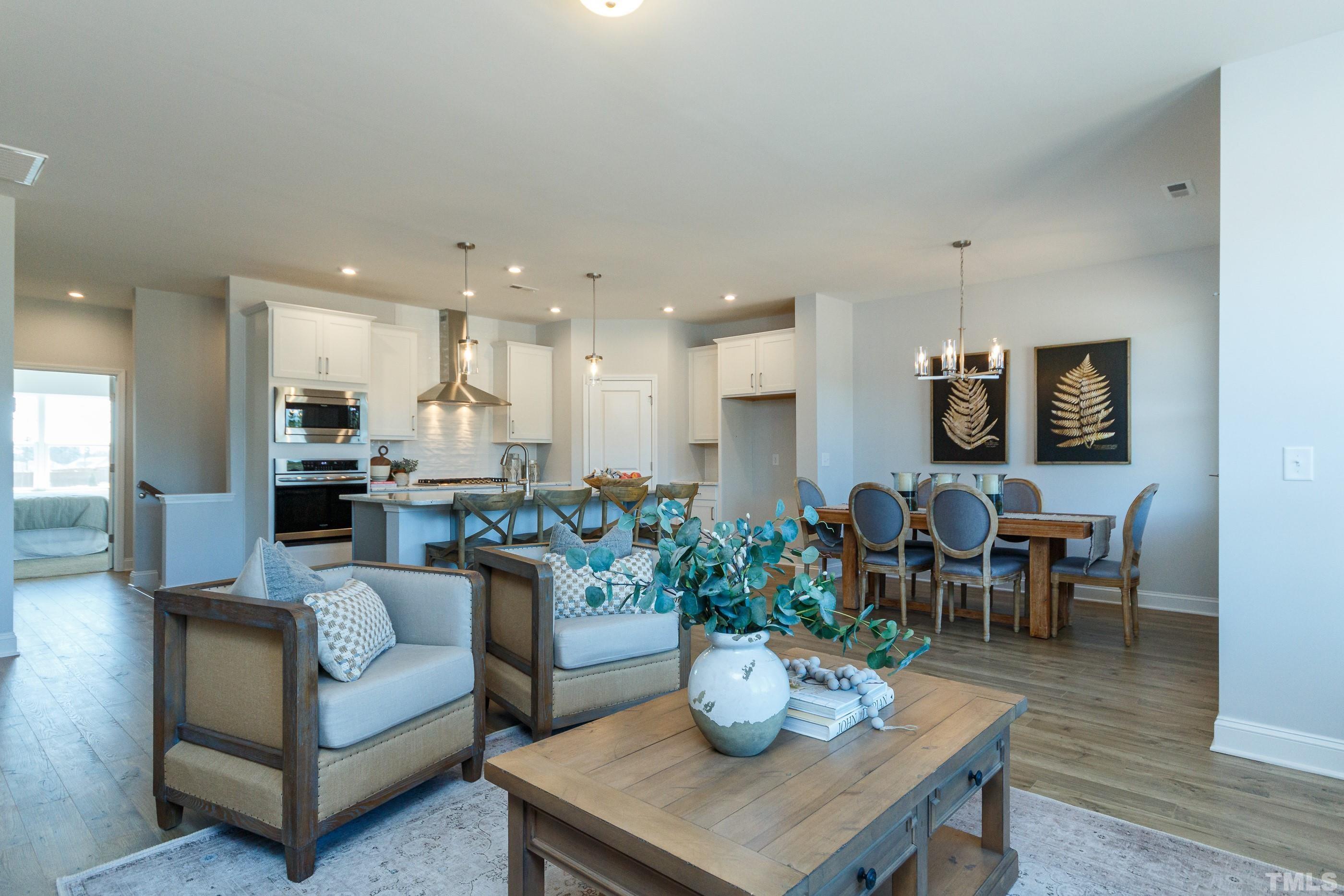 3109 Dunnock Drive, Unit 5 Durham, NC 27713 - Photo 6 of 25 a view of a dining room with furniture and wooden floor
