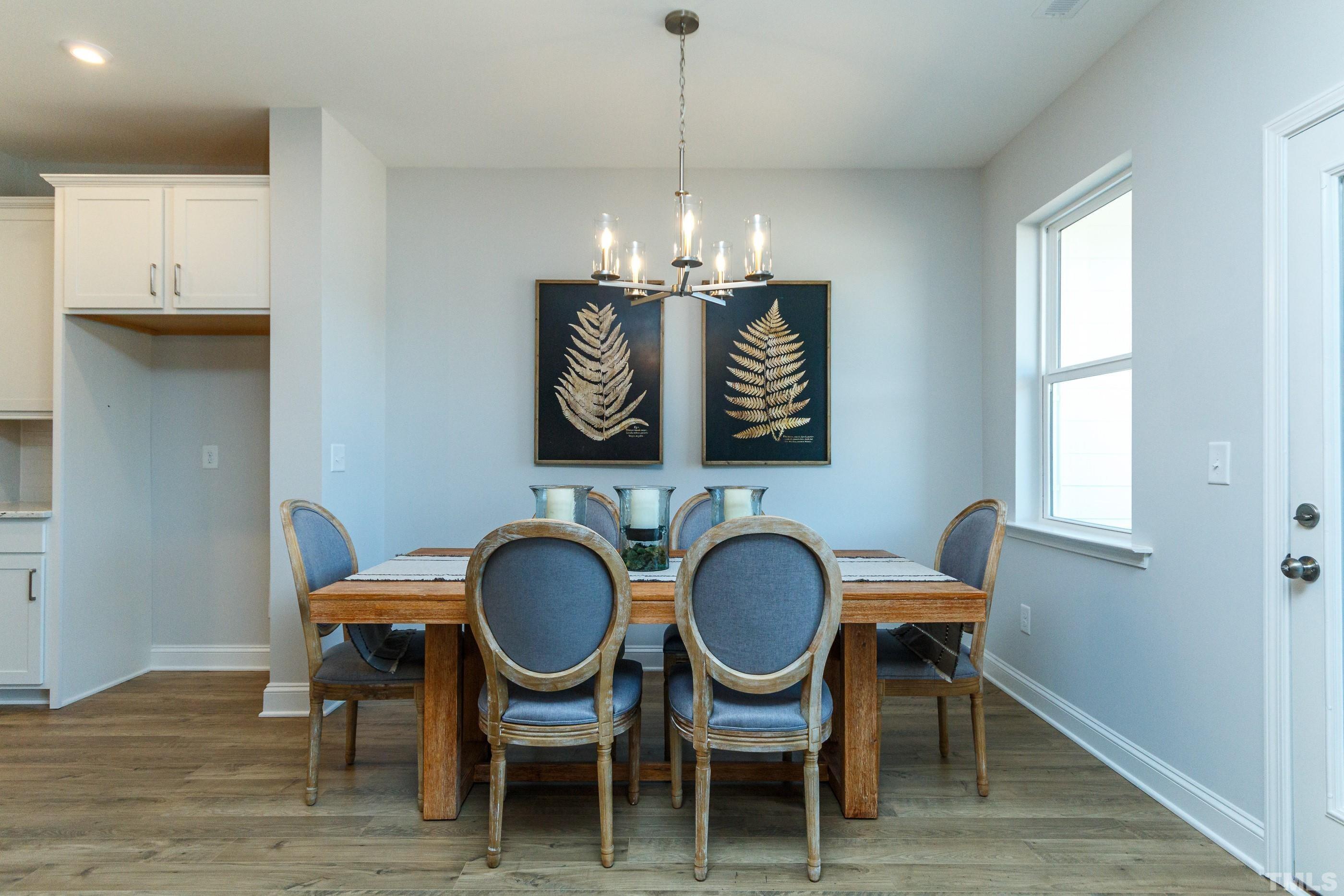 3109 Dunnock Drive, Unit 5 Durham, NC 27713 - Photo 8 of 25 a dining room with furniture a rug and wooden floor