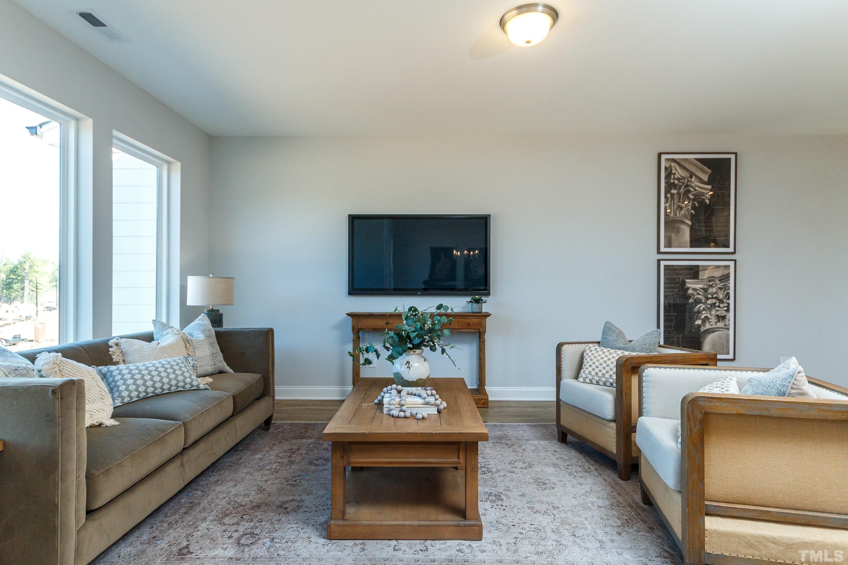 3109 Dunnock Drive, Unit 5 Durham, NC 27713 - Photo 10 of 25 a living room with furniture and a flat screen tv