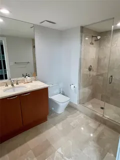 a spacious bathroom with a tub sink mirror and toilet