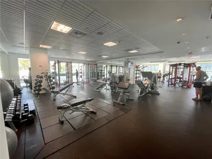 a view of a room with gym equipment and a large window