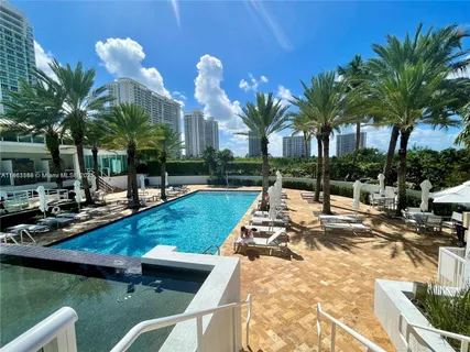a view of a swimming pool and lounge chairs